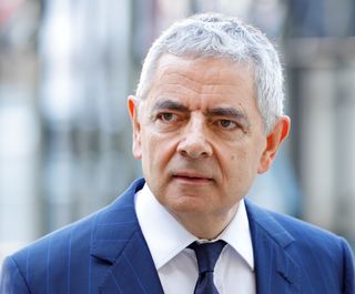 Rowan Atkinson attends a Service of Thanksgiving for the life and work of Sir Stirling Moss at Westminster Abbey on May 8, 2024 in London, England. The former Formula 1 motor-racing driver died on 12 April 2020, during the Covid pandemic, in London at the age of 90.