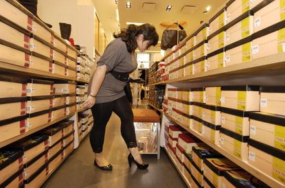 A woman tries shoes on at a Payless in Manhattan.
