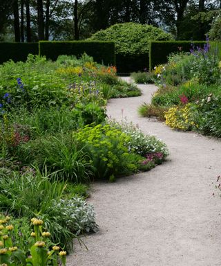serpentine path through flowerbeds like the style used in Georgian garden design National Trust