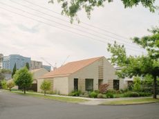 Hanslope House, a light brick pavilion home with a double pitched roof in a rare double corner suburban plot
