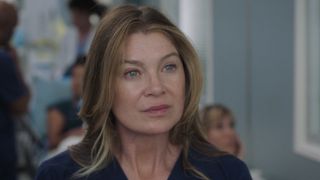 Meredith in blue scrubs meeting her new boss in the Season 23 premiere. 