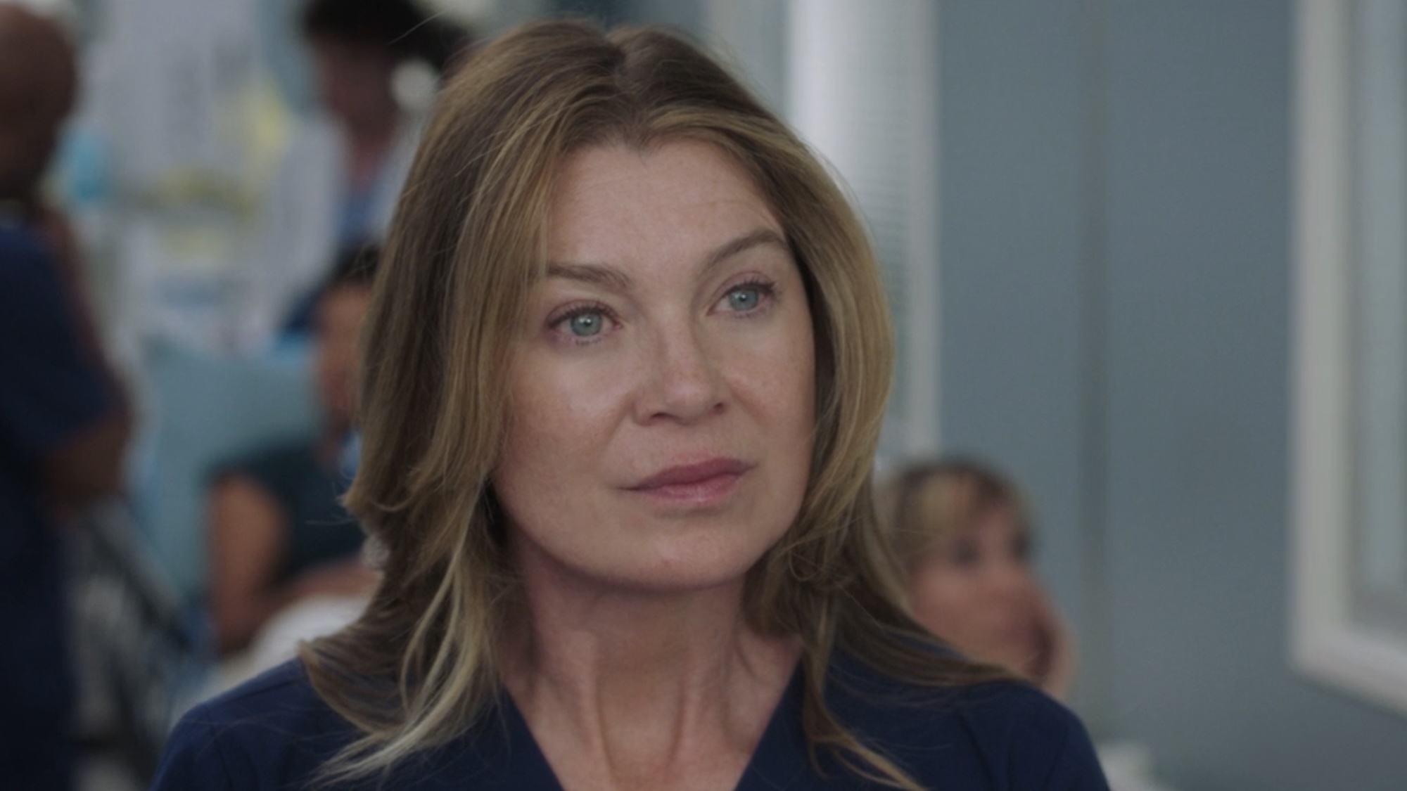 Meredith in blue scrubs meeting her new boss in the Season 23 premiere. 