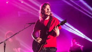 Opeth‘s Mikael Akerfeldt performing onstage in 2012