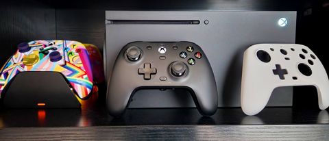 GameSir G7 Wired Controller propped against Xbox Series X with white faceplate and Xbox Wireless Controller to the side.