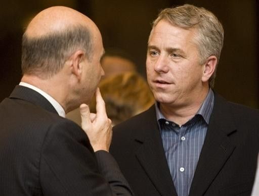Former Tour de France winner Greg Lemond (R) talks with an old acquaintance,