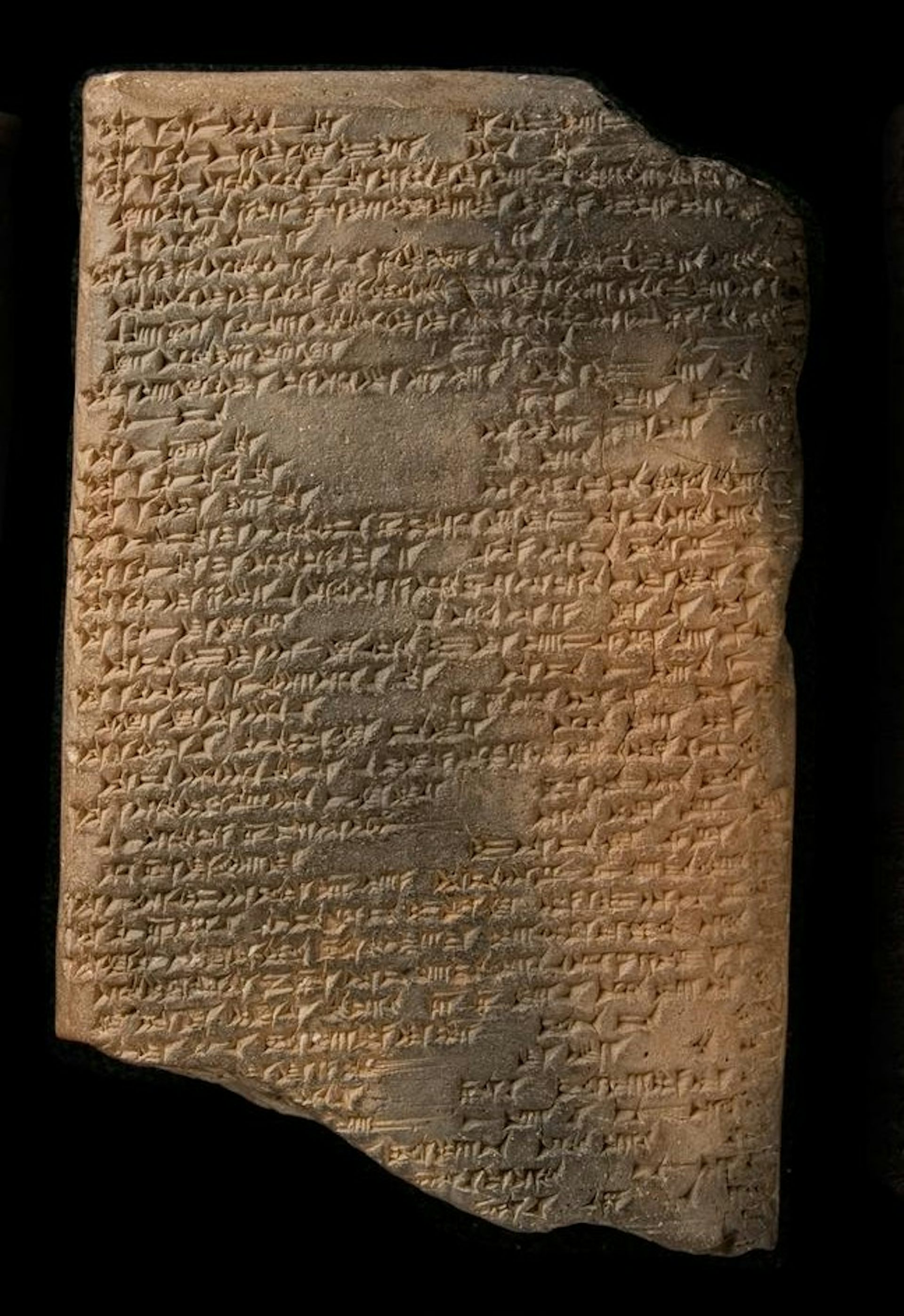 Neo-Assyrian clay tablet against a black background