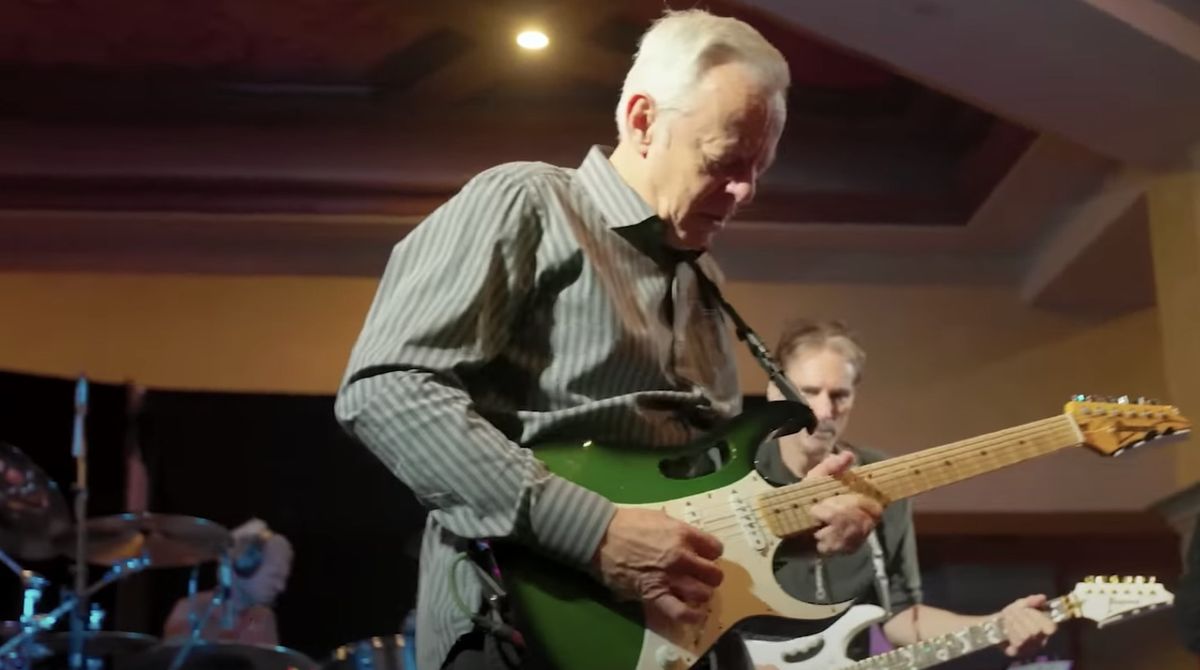 Tommy Emmanuel (left, foreground) jams with Steve Vai (background) at Vai Academy 6.0 in Las Vegas, Nevada