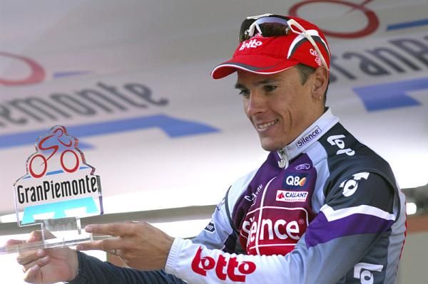 Race winner Philippe Gilbert on the podium with the Giro del Piemonte trophy.