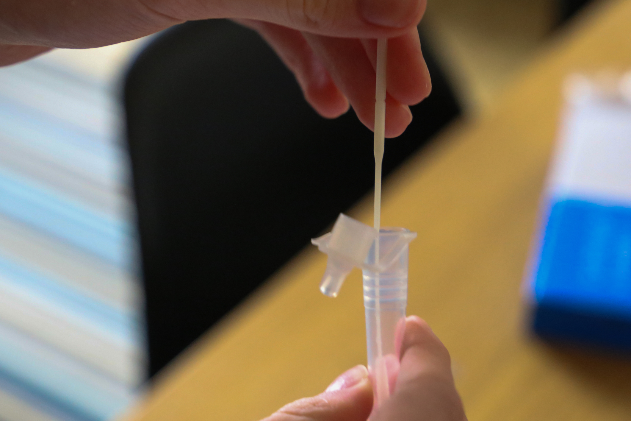 Person taking lateral flow test to combat the spread of the new Delta variant