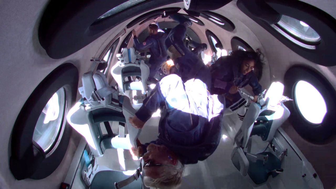 Virgin Galactic founder Richard Branson (foreground) and his crew float in weightlessness aboard the VSS Unity spacecraft during their suborbital Unity 22 spaceflight on July 11, 2021.