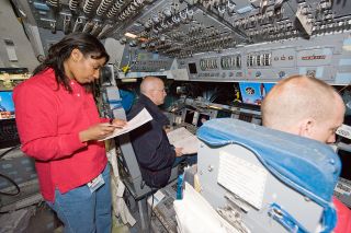 Members of NASA's STS-131 crew, including astronauts Stephanie Wilson, Alan Poindexter and Clay Anderson, train in the Guidance and Navigation Simulator (GNS) at NASA's Johnson Space Center in Houston in January 2010.