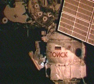 Russian cosmonaut works on the space station’s Poisk module.