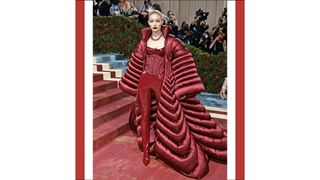 Gigi Hadid wears a red jumpsuit and coat as she attends The 2022 Met Gala Celebrating "In America: An Anthology of Fashion" at The Metropolitan Museum of Art on May 02, 2022 in New York City.