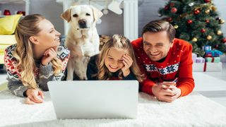 Family with a dog watching a Christmas movie