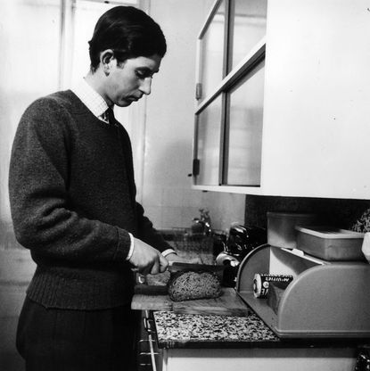 Prince Charles slicing bread in his apartment 