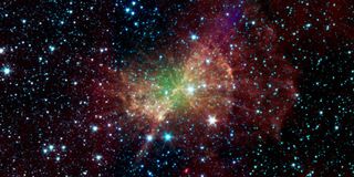 The Dumbbell Nebula, also known as Messier 27, pumps out infrared light in this image from NASA's Spitzer Space Telescope. T