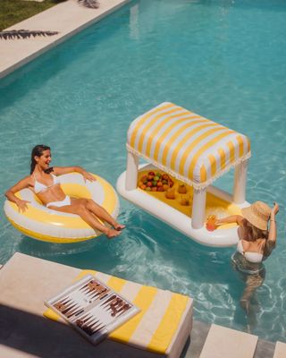 A cabana bar floats in a pool