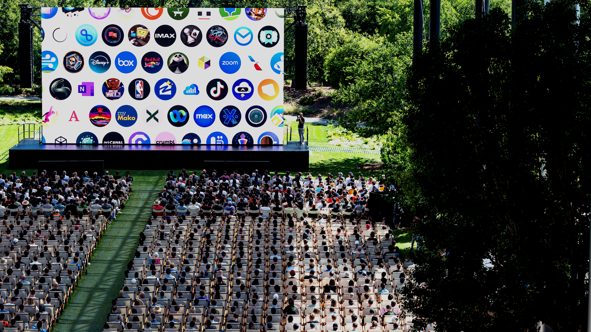 Attendees watch the keynote presentation during the Apple Worldwide Developers Conference at Apple Park campus in Cupertino, California, US, on Monday, June 10, 2024. The conference will show whether Apple Inc. can become a major player in the burgeoning field of artificial intelligence, marking a critical moment for a company forced to adapt to a new era. Photographer: David Paul Morris/Bloomberg via Getty Images