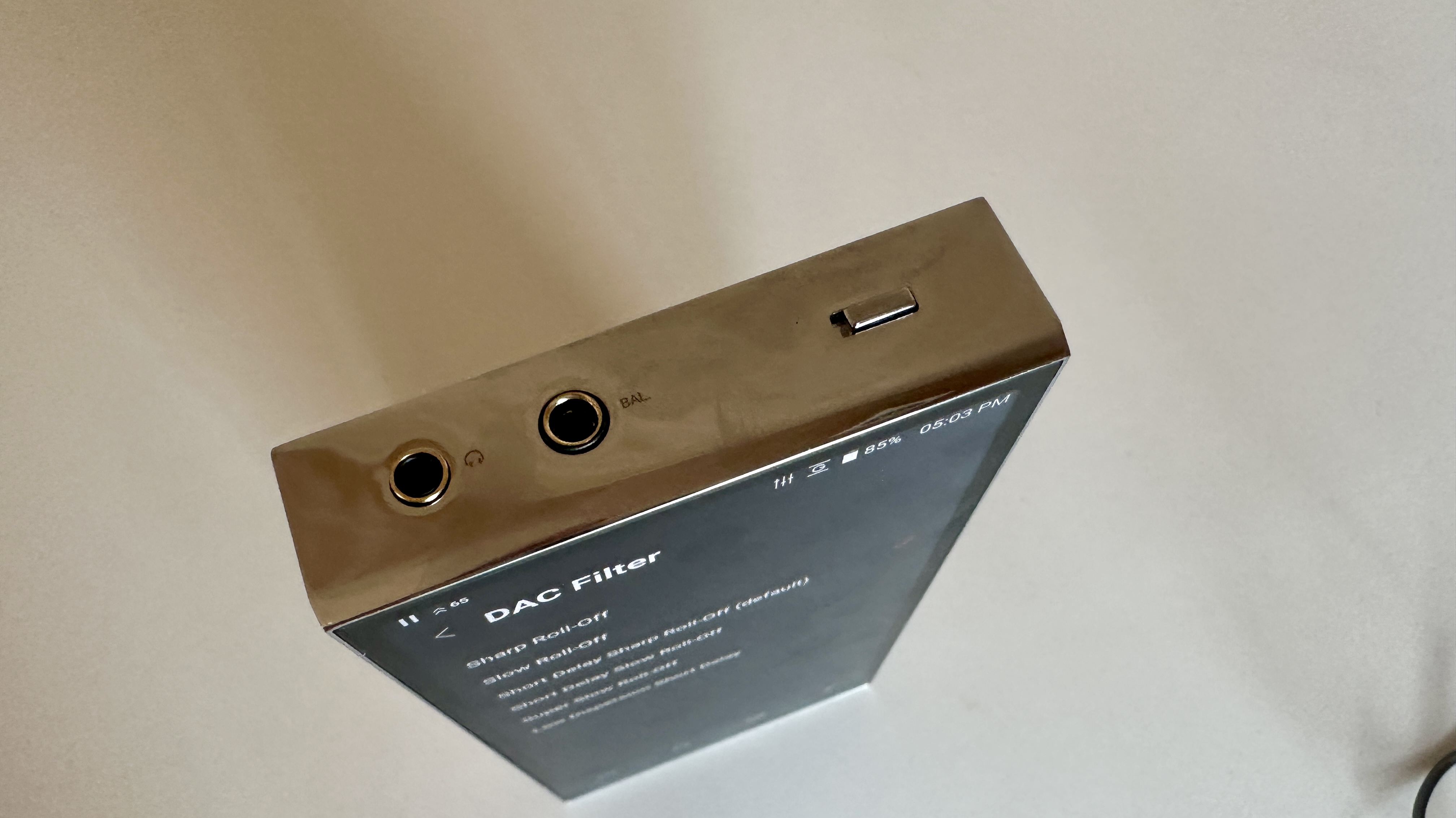 Top panel, showing 3.5mm and 4.4mm headphone ports, of the Astell &amp;amp; Kern A&amp;amp;ultima SP4000 portable music player on a white surface