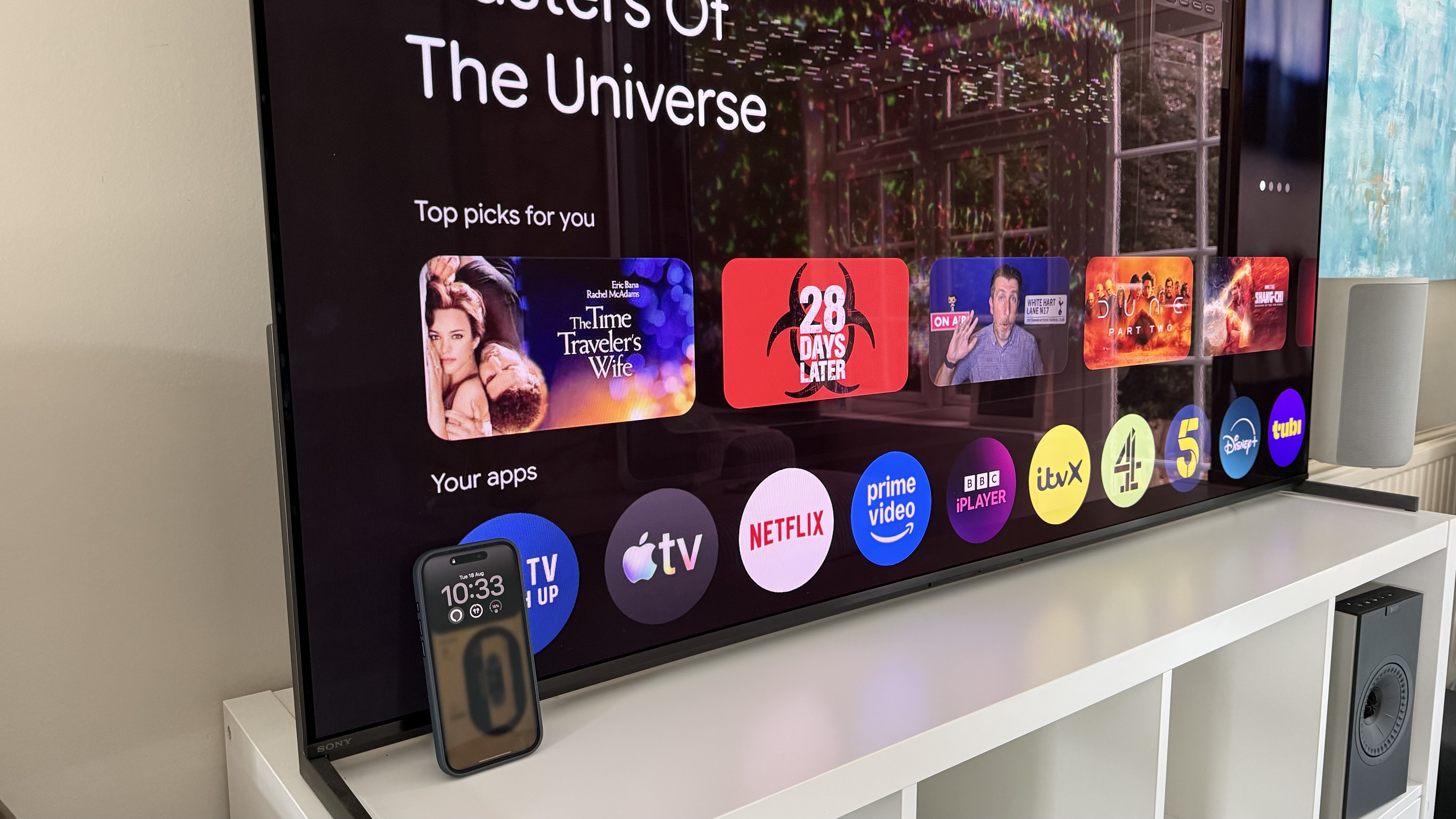 A photo of an iPhone resting against a TV.