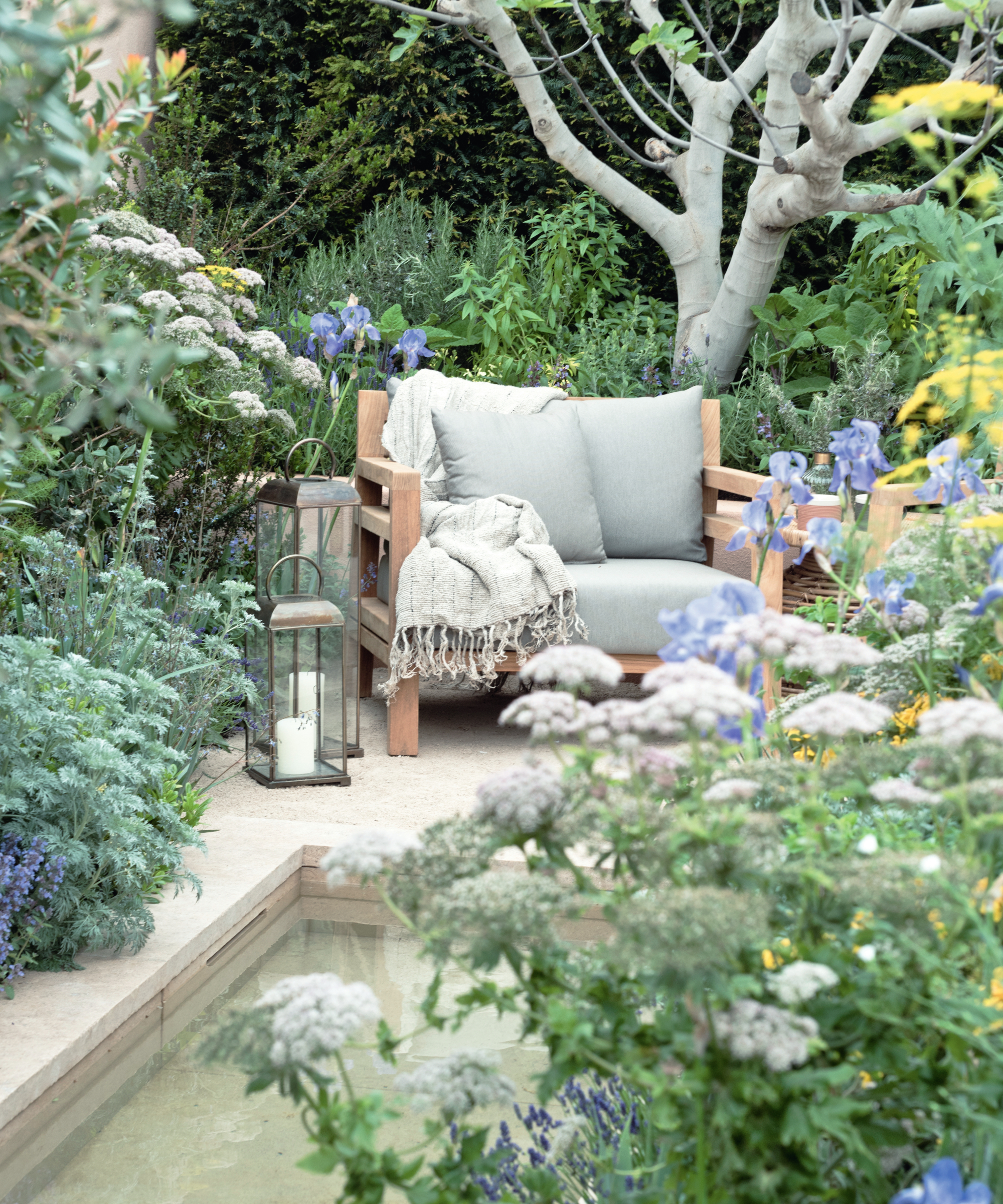 cosy garden corner with heavily planted areas surrounding water feature