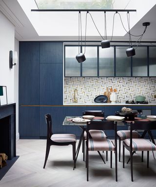blue kitchen with dining table and roof light