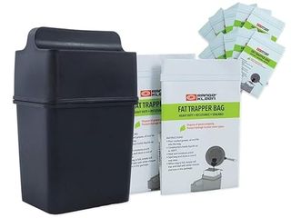 A small back waste bin, besides white cardboard boxes of fat trapper bags.