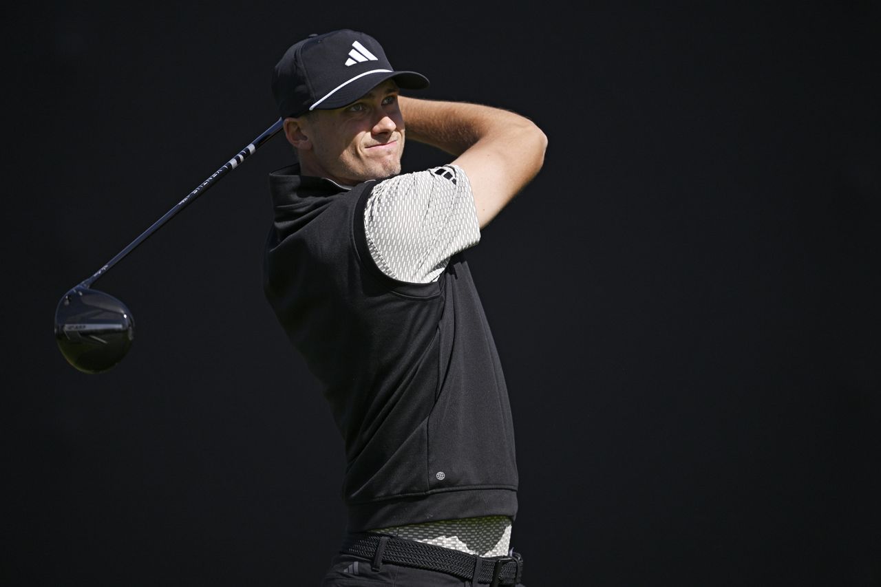 Ludvig Aberg watches a tee shot holding a driver
