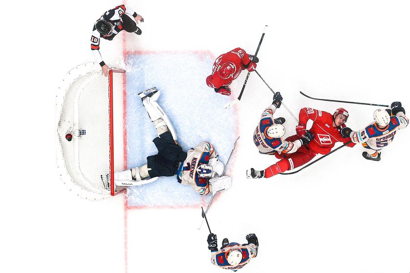 Top-down view of ice hockey goal and players 