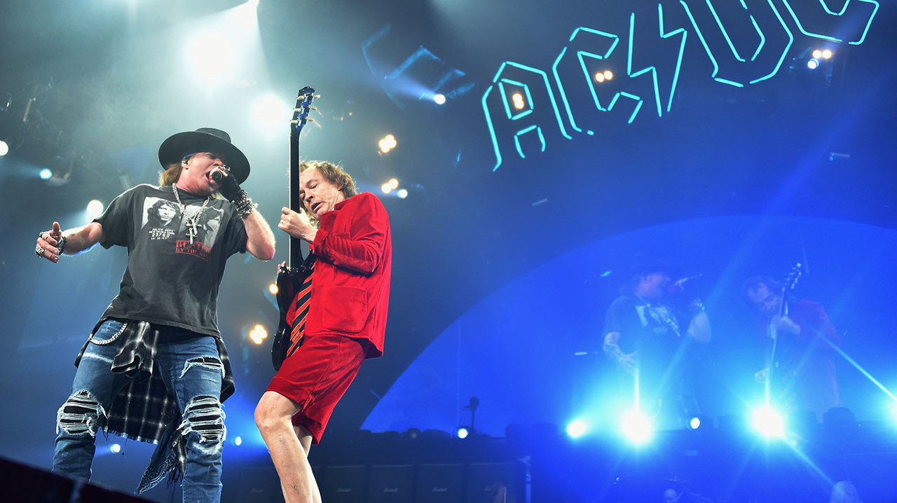 Axl Rose onstage with Angus Young