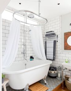 bathroom with white curtains and bathtub and white brick tiles wall