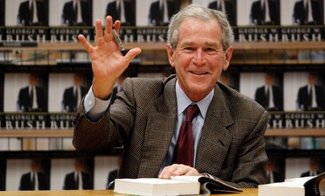 Former President George W. Bush waves while signing copies of his memoir Decision Points in Dallas in 2010. 