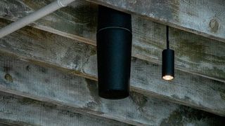 A SoundTube pendant speaker discretely hangs at a brewery.