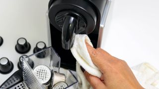 A capsule coffee machine being cleaned