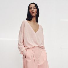 Model wears pink jumper and pink trousers