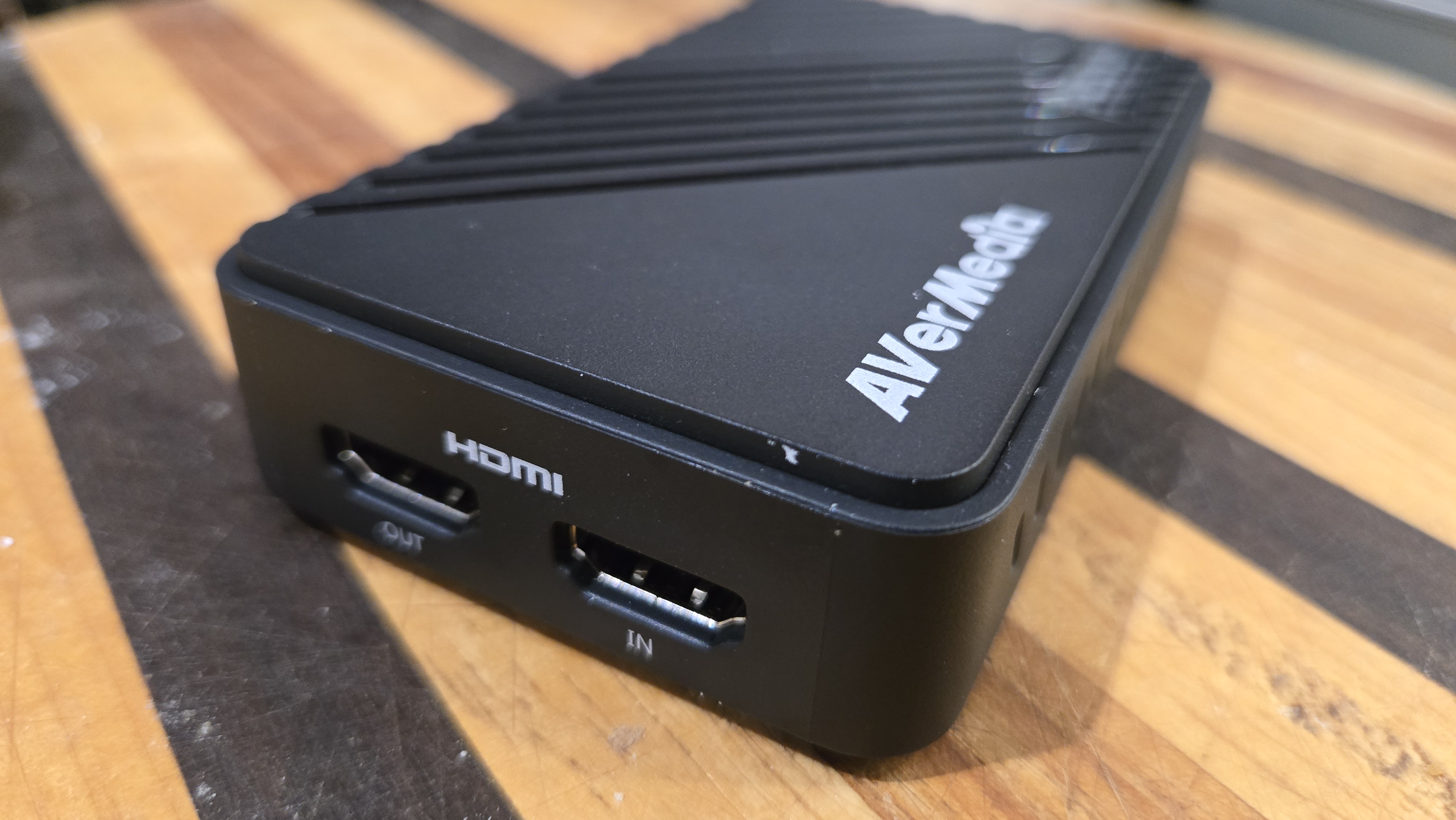 An AverMedia external capture card on a chair.