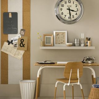 chair and table with clock on wall