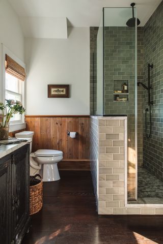 rustic bathroom with green tile shower