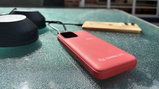 Laser ChargeCore powerbank charging a phone and pair of headphones