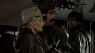 Sally Kallerman looking annoyed, in army green, in M*A*S*H