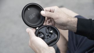 the shure aonic 215 2nd gen true wireless earbuds in their charging case