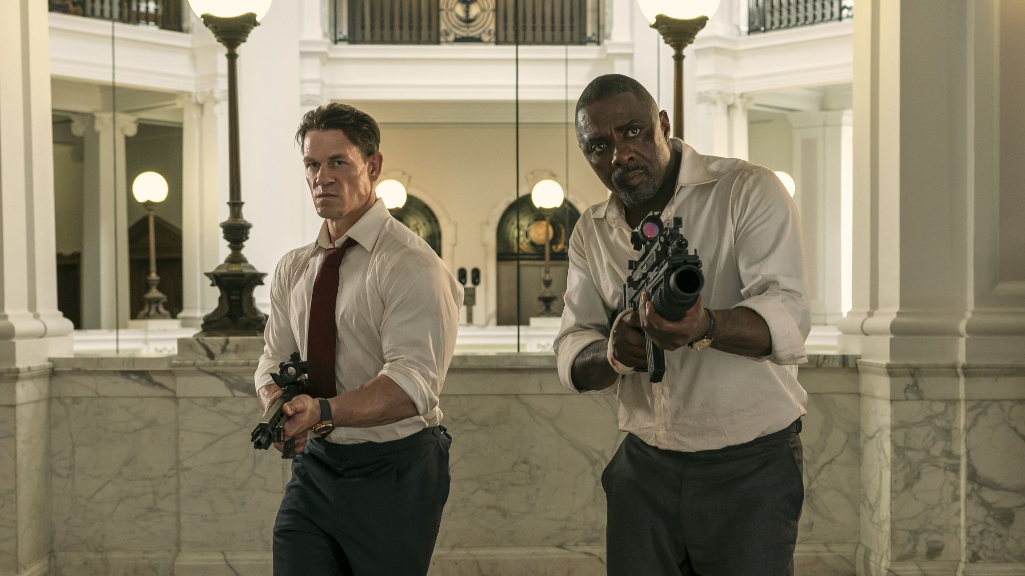 John Cena and Idris Elba holding guns in Heads of State