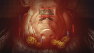 A pig's head sits atop a birthday cake with the Chinese character for 'libation' painted on its face.