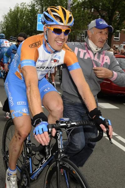 Tyler Farrar (Garmin-Transitions) is guided to the podium after his win