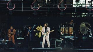 Eric Clapton (centre) performs with Mark Knopfler of Dire Straits (Left) and Elton John (far right) at The Silver Clef Award Winners Concert 'Knebworth '90', on June 30th, 1990 in Knebworth, United Kingdom.