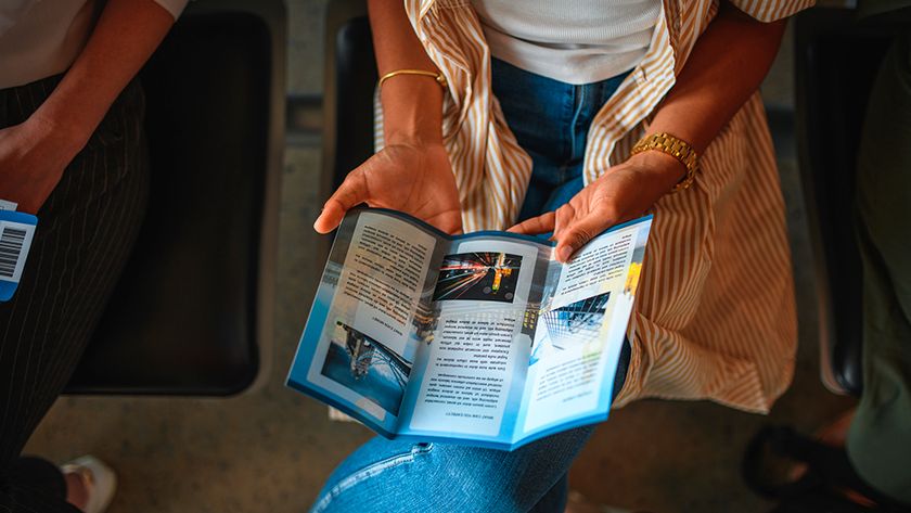 A woman reads a printed leaflet