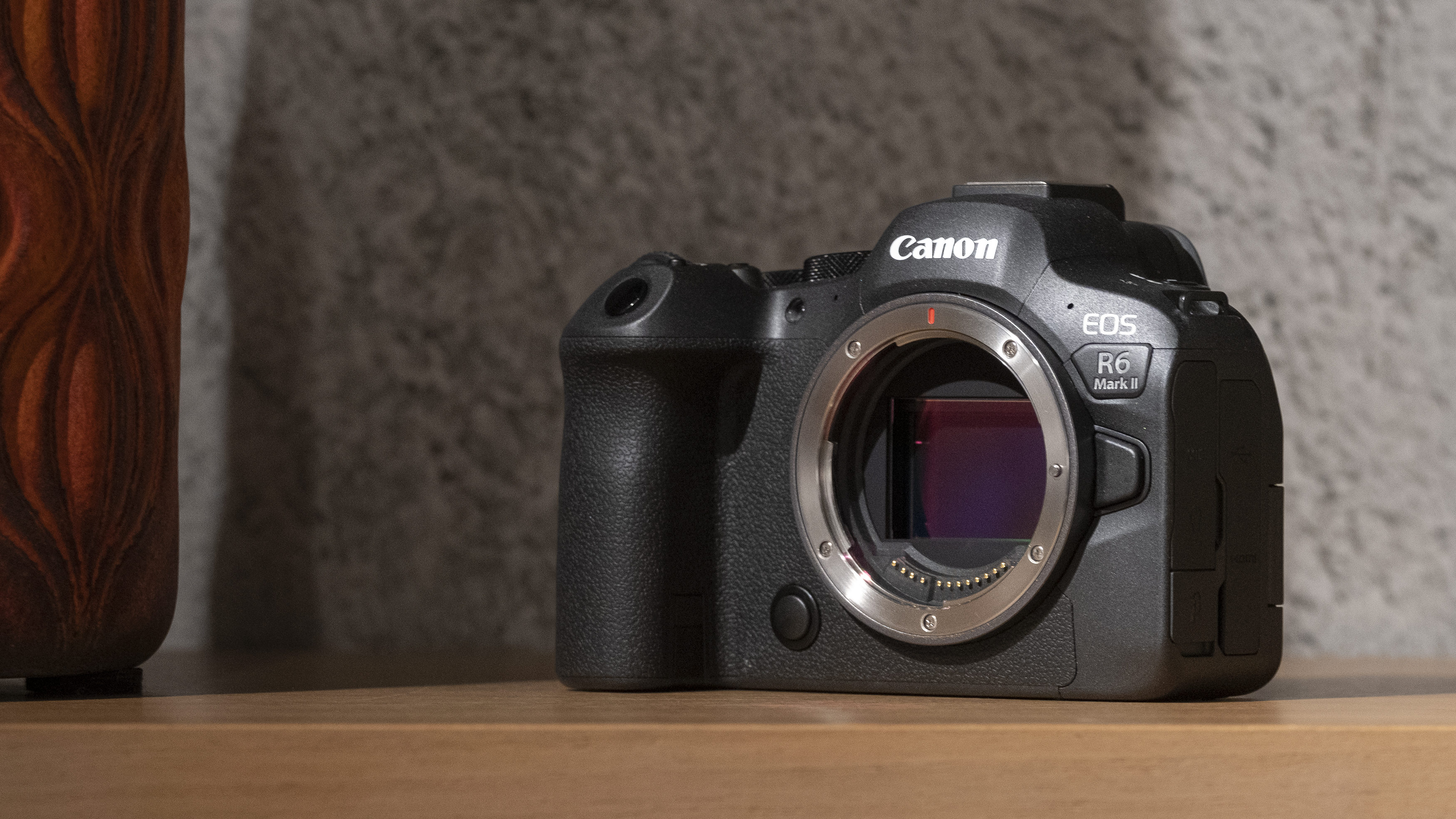 The Canon EOS R6 Mark II camera on a wooden shelf