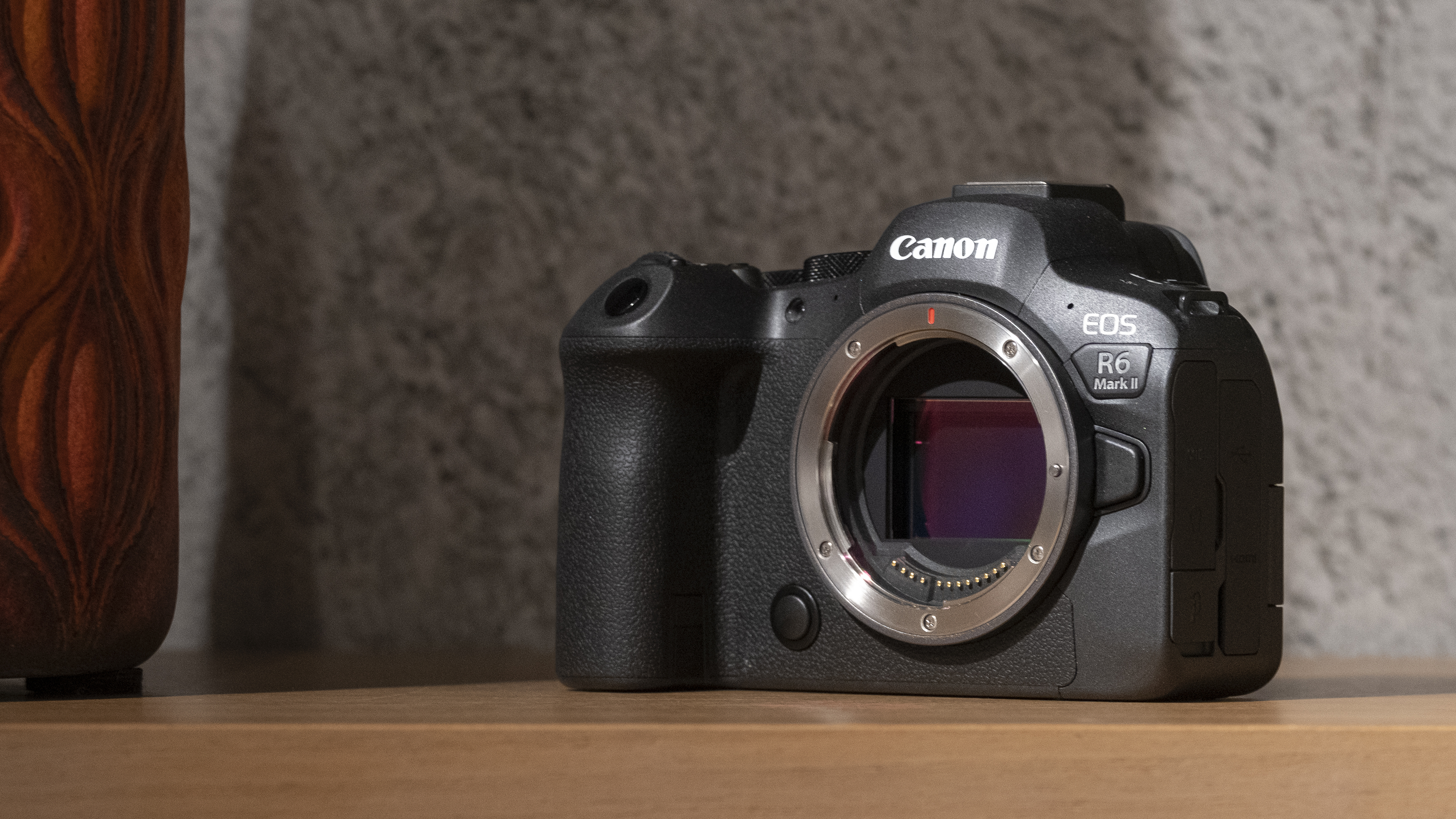 The Canon EOS R6 Mark II camera connected  a woody  shelf