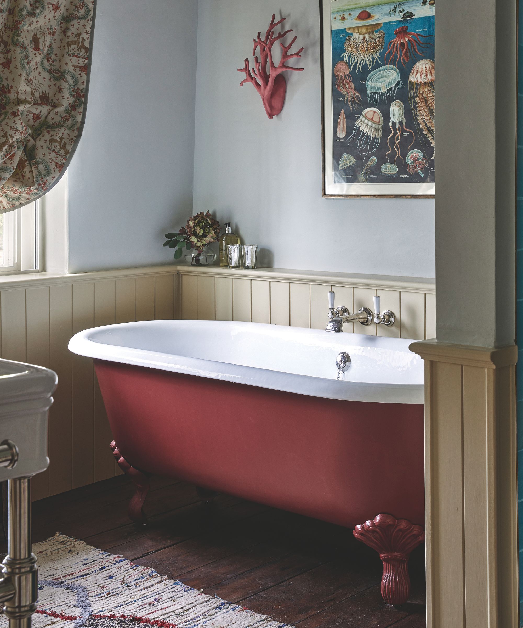Burgundy roll top bath in neutral bathroom