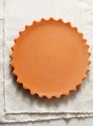 orange bloco color plate with a sharp scalloped rim